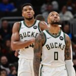 Milwaukee Bucks forward Giannis Antetokounmpo (34) and guard Damian Lillard (0) look on