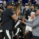 Dec 17, 2024; Las Vegas, Nevada, USA; Milwaukee Bucks forward Giannis Antetokounmpo (34) hands the trophy to head coach Doc Rivers after winning the Emirates NBA Cup championship game against the Oklahoma City Thunder at T-Mobile Arena. Mandatory Credit: Kyle Terada-Imagn Images