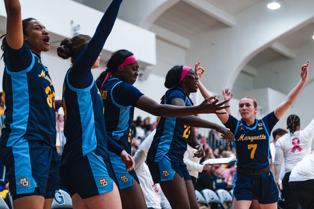 The Marquette women’s basketball bench celebrates during a road game against Georgetown in the 2024-25 season.