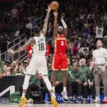 Atlanta Hawks guard Caris LeVert (3) shoots over Milwaukee Bucks forward Kyle Kuzma (18) during the second half at State Farm Arena.