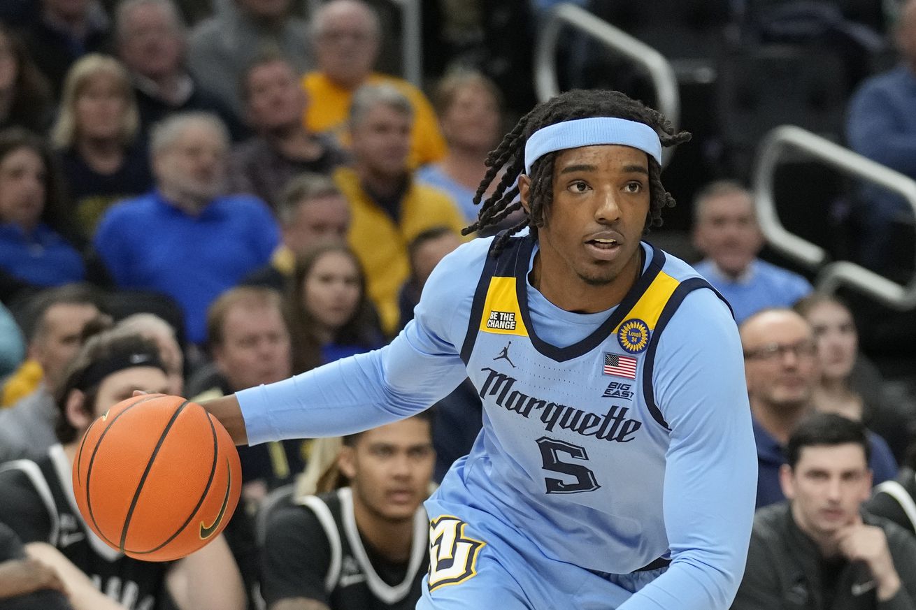 Tre Norman #5 of the Marquette Golden Eagles dribbles the ball against the Providence Friars during the first half at Fiserv Forum on February 25, 2025 in Milwaukee, Wisconsin.