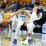 Indiana Pacers guard Tyrese Haliburton (0) dribbles the ball while Milwaukee Bucks forward Giannis Antetokounmpo (34) defends
