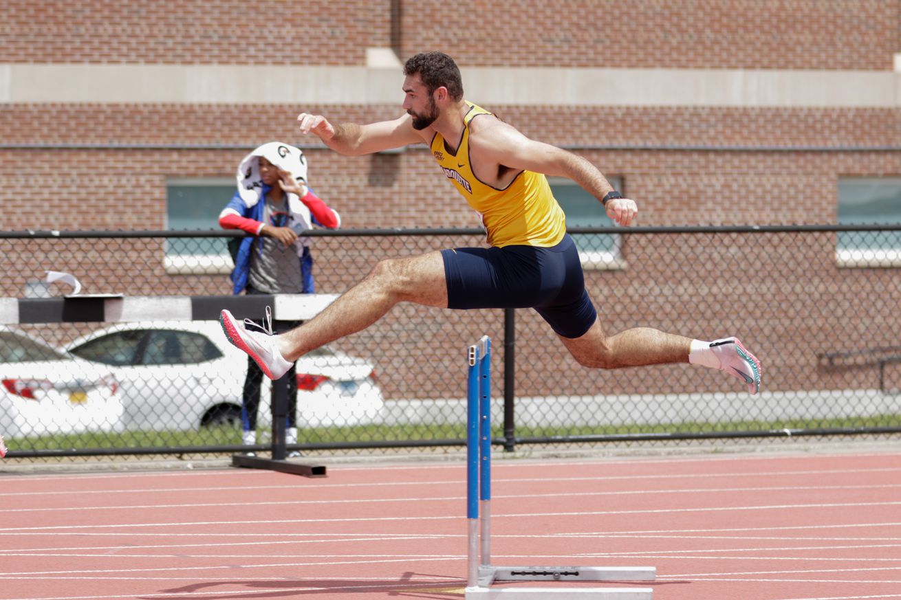 Mitchell Van Vooren running hurdles for Marquette.