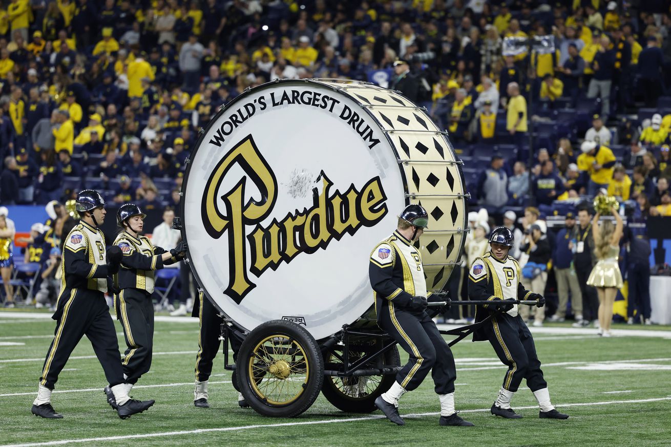 Purdue Boilermakers marching band pushes the World’s Largest Drum onto the field prior to the Big 10 Championship college football game against the Michigan Wolverines on December 3, 2022 at Lucas Oil Stadium in Indianapolis, Indiana.