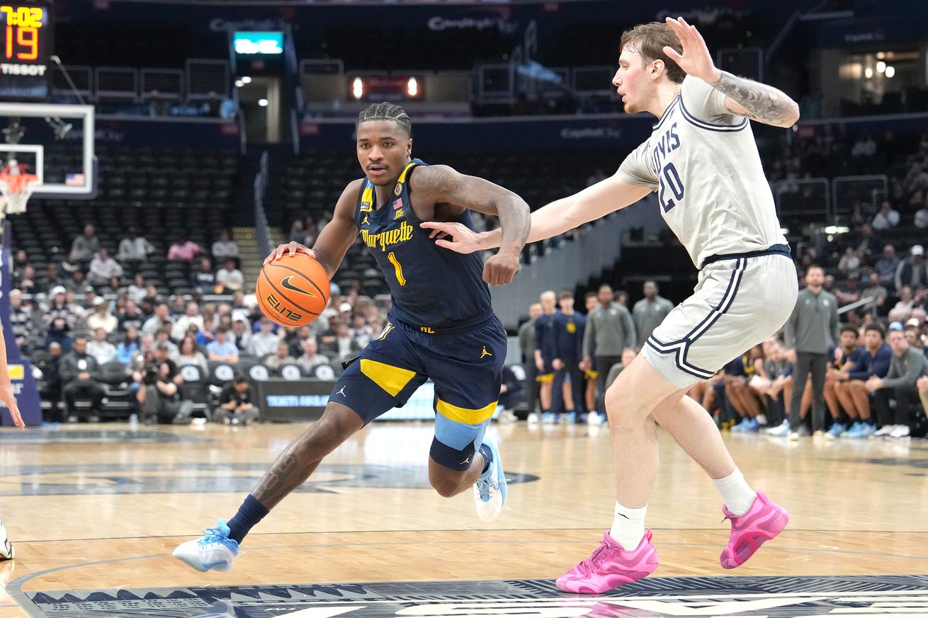Kam Jones #1 of the Marquette Golden Eagles drives to the basket past Drew Fielder #20 of the Georgetown Hoyas in the first half during a college basketball game against the Marquette Golden Eagles at the Capital One Arena on March 1, 2025 in Washington, DC.