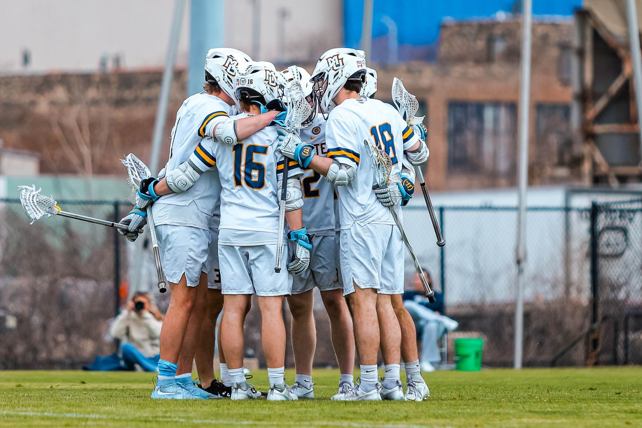 Marquette men’s lacrosse players huddling up during a 2025 game against Georgetown