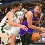 Mar 13, 2025; Milwaukee, Wisconsin, USA; Milwaukee Bucks center Brook Lopez (11) defends Los Angeles Lakers guard Luka Doncic (77) in the third quarter at Fiserv Forum. Mandatory Credit: Benny Sieu-Imagn Images