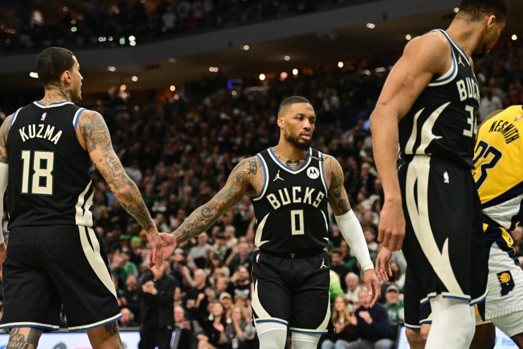 Milwaukee Bucks guard Damian Lillard (0) reacts with forward Kyle Kuzma