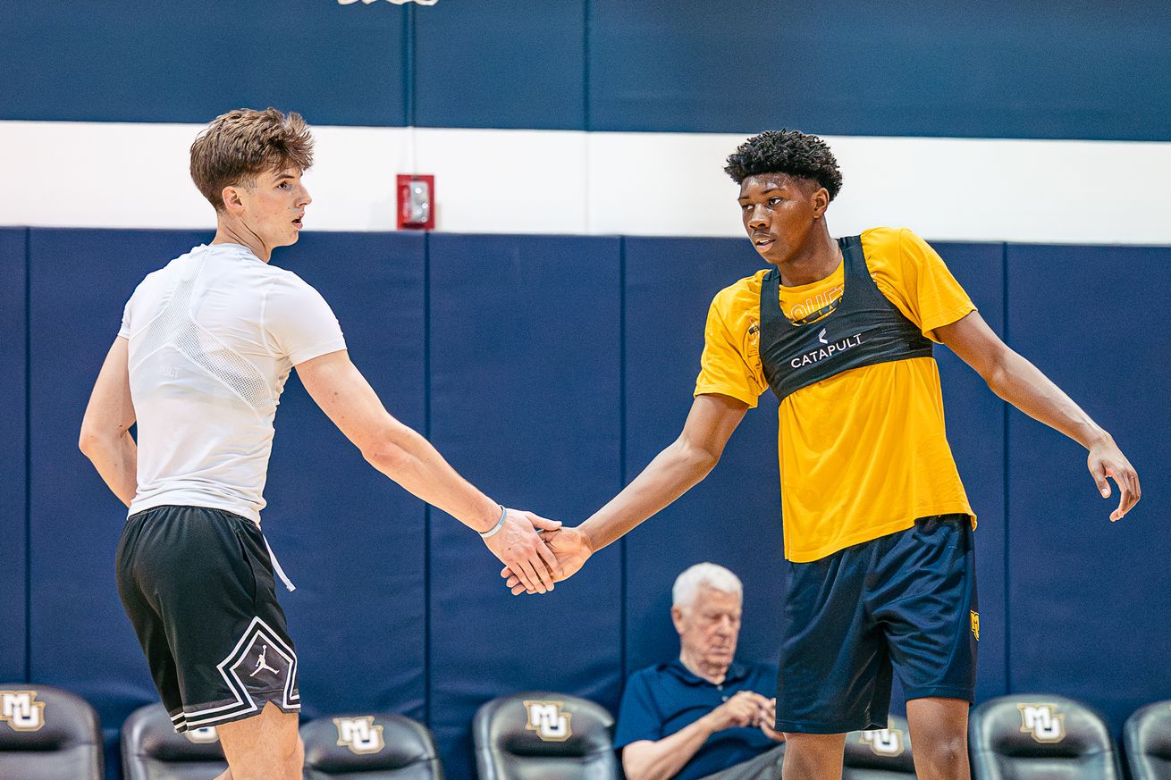 Marquette’s Ian Miletic & Michael Phillips II high five at a summer workout in 2025.