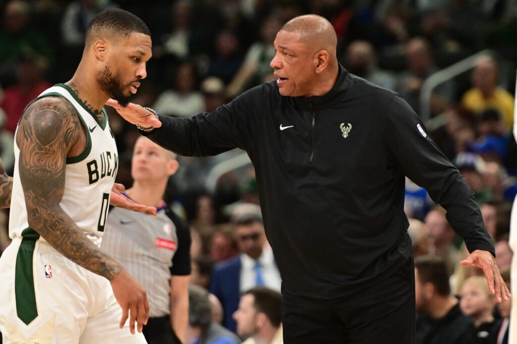 Milwaukee Bucks head coach Doc Rivers pats guard Damian Lillard