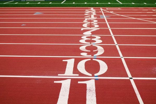 Numbers along the starting line on a running track. Original public domain image from Wikimedia Commons.